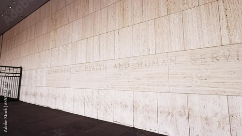 ‘Department of Health and Human Services’ text engraved on the side of the Hubert H. Humphrey Building, the agency headquarters of HHS located in downtown Washington, DC. The camera pans to the right. photo