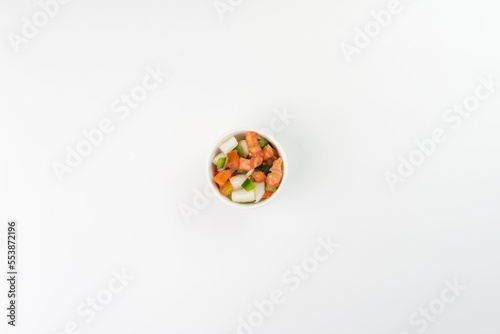 Delicious vinaigrette with tomato, onion, bell pepper on white background. Top view. Typical Brazilian food. Selective focus