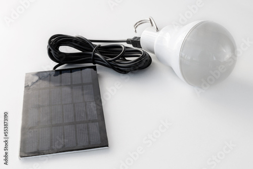 Autonomous rechargeable light bulb with solar panel, on a white background photo