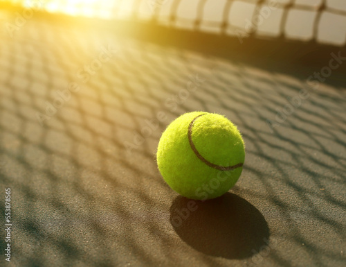 Close-up shot of a tennis ball on a tennis court. Exercise for health on vacation.