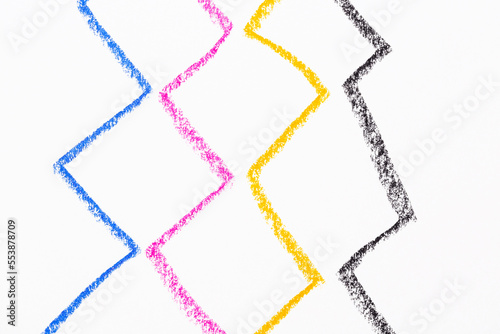 Crayon hand drawing in a zigzag line using four colors on a white background photo