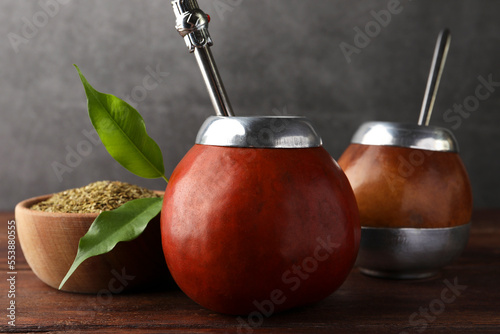 Calabash with mate tea and bombilla on wooden table