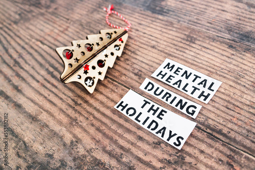 Obraz na plátně mental health during the holidays text next to festive Christmas decoration, man