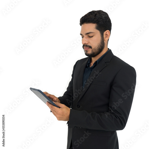 Young businessman with moustache and beard in black suit typing on tablet computer. Portrait on white background with studio lighting. Isolated