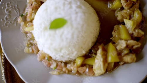 tasty rice with chicken and pineapple plate good looking for the camera with a green leaf on top as culinarie shoot  photo