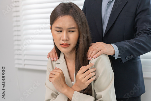 Fototapeta Naklejka Na Ścianę i Meble -  Unhappy, disgusted asian young employee, business woman defending hand of colleague, push out protect when boss touching her body, embrace shoulder. Sexual harassment inappropriate at office,workplace