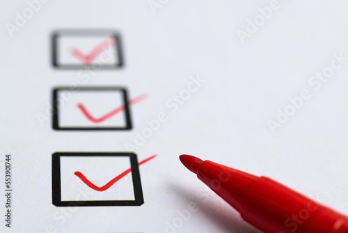 Red pen marking on checklist sheet