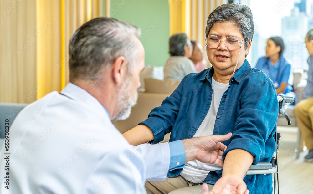 Happy patient and doctor, rehabilitation after injuries, male physiotherapist raising hands of active senior woman in hospital, Musculoskeletal Pain Therapy and Rehabilitation Concept for Senior Happy patient and doctor, rehabilitation after injuries, male physiotherapist raising hands of active senior woman in hospital, Musculoskeletal Pain Therapy and Rehabilitation Concept for Senior