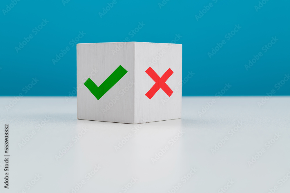 Wooden cube with tick and cross Wooden cube with tick and cross