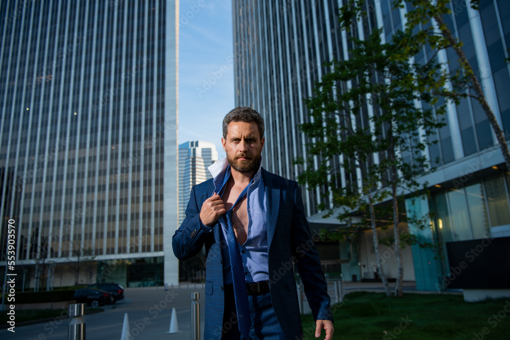 Angry businessman in suit after work in office. Screaming face. Business man take off tie after working. Angry businessman in suit after work in office. Screaming face. Business man take off tie after working.