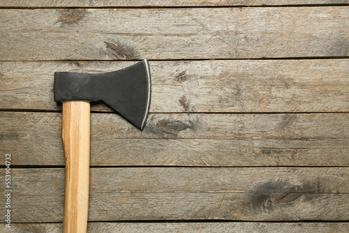 Ax on wooden background, to...