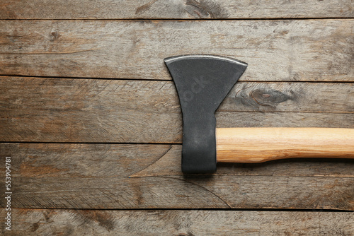 Ax on wooden background, to...