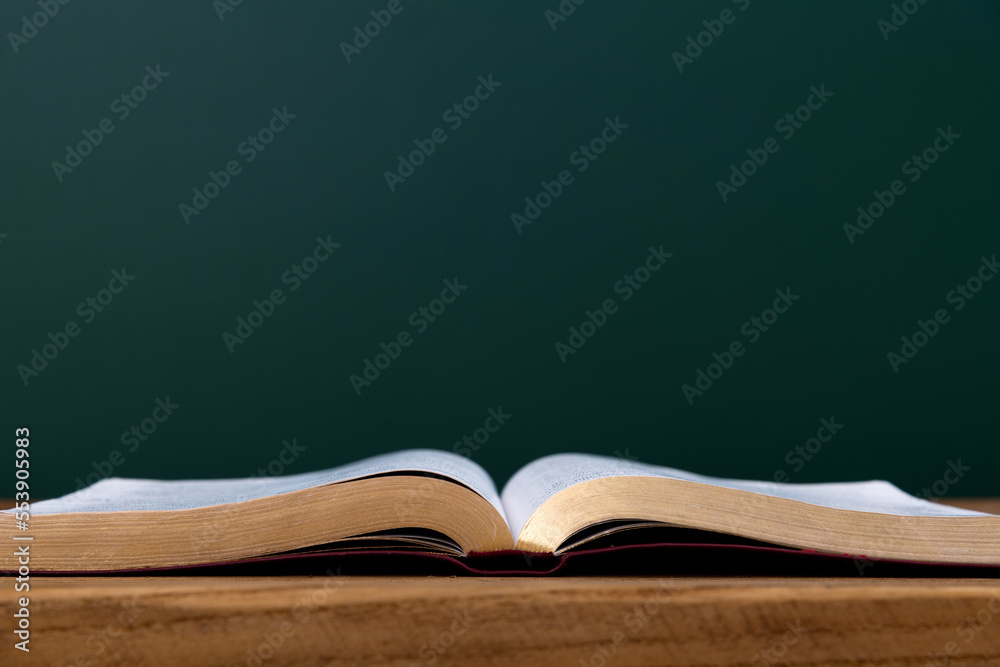 Open book in front of the blackboard Open book in front of the blackboard
