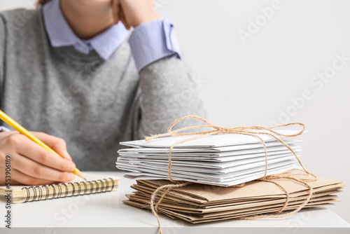 Stack of tied letters on table, closeup. Mail concept