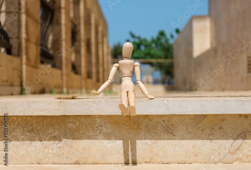 Wooden mannequin on step outdoors, closeup
