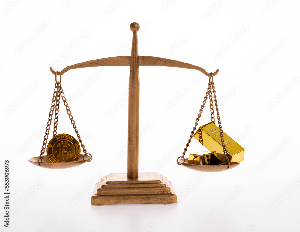 The balance holds gold bar and bitcoin The balance holds gold bar and bitcoin