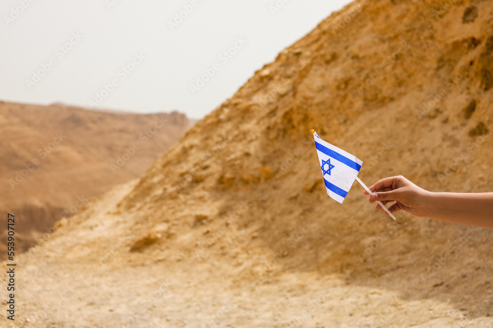 Little girl with flag of Israel in desert, closeup Little girl with flag of Israel in desert, closeup