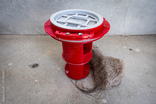 Household vacuum cleaner filter clogging up with dust, mite, hair, and animal fur after an extensive household cleaning : allergy, unhygienic concept photo