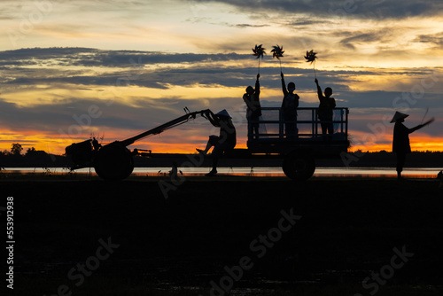 Asian Men and Women Gathering farmers produce rice export in rural communities. in the Morning, Light as a Silhouette
