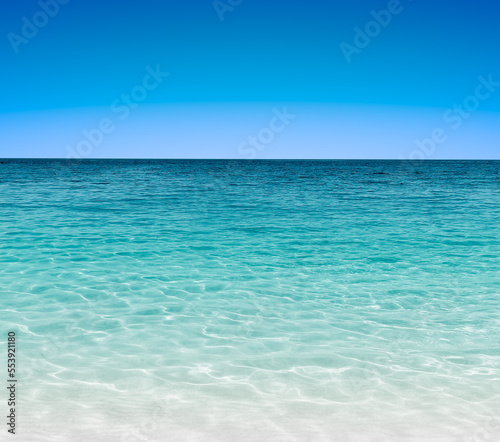 Seascape with turquoise water ripple and blue sky