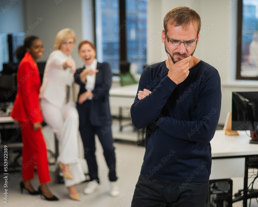 A middle-aged man is upset because of the ridicule of his female colleagues. Discrimination against men in the office. 