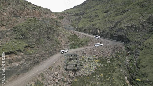 White tourism SUVs near top of gravel Sani Pass switchbacks to Lesotho photo