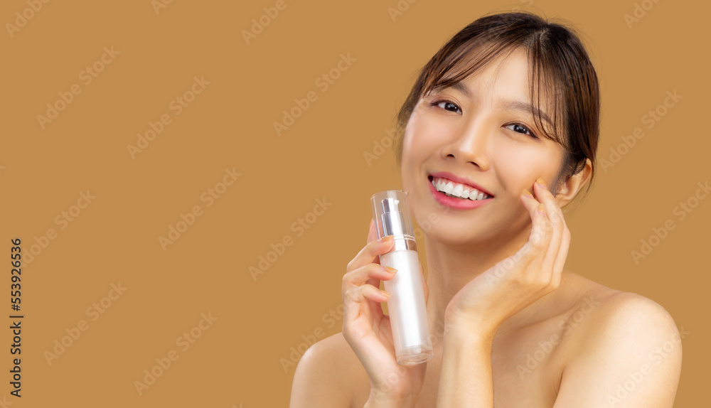 Beauty asian woman portrait face with skin care healthy and skin holding bottle of serum looking camera on beige color background. Beauty asian woman portrait face with skin care healthy and skin holding bottle of serum looking camera on beige color background.