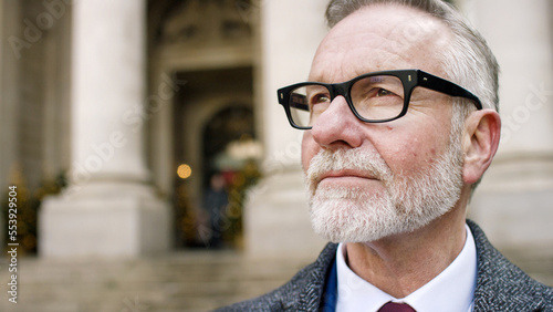 фотографія Portrait of attractive senior business man in the city, with space for text