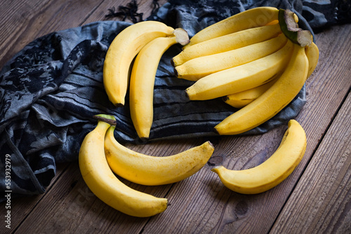 bunch of bananas - banana on wooden background, ripe banana fruit on floor