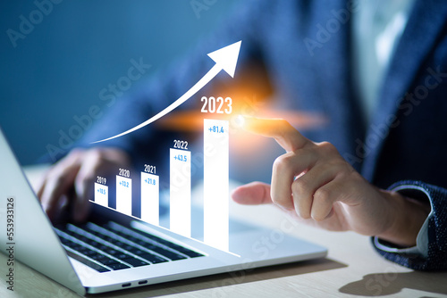 Businessman analysis growth of business direction in 2023, use charts and virtual screens to display data, and forecast financial conditions. And the future economy, investment data analysis..