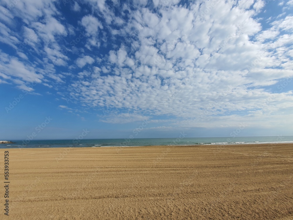 Wonderful empty and wide open beachfront on a sunny day with some clouds. space for text. Wonderful empty and wide open beachfront on a sunny day with some clouds. space for text.