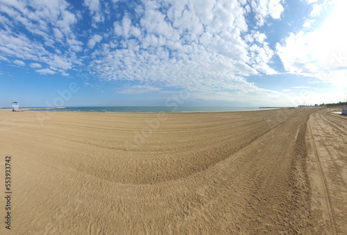 Awesome panoramic beach view: Wonderful empty and wide open beachfront on a sunny day with some clouds. space for text.