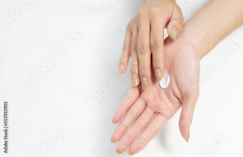Fototapeta Naklejka Na Ścianę i Meble -  Woman applying cream on clean hand for beauty and spa treatment skin care on white background.