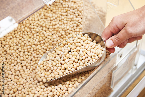 Hand with scoop takes chickpeas