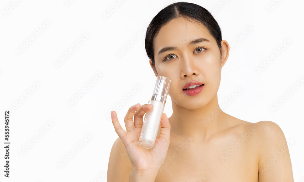 Young beautiful asian woman clean face holding bottle of serum on white background. Beauty and skin care. Young beautiful asian woman clean face holding bottle of serum on white background. Beauty and skin care.