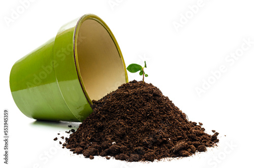 Earth spilled out of a flower pot on a white background