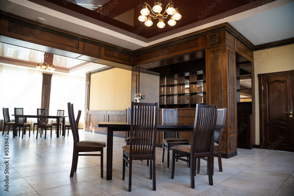 spacious interior of modern empty large restaurant with tables and chairs. spacious interior of modern empty large restaurant with tables and chairs.