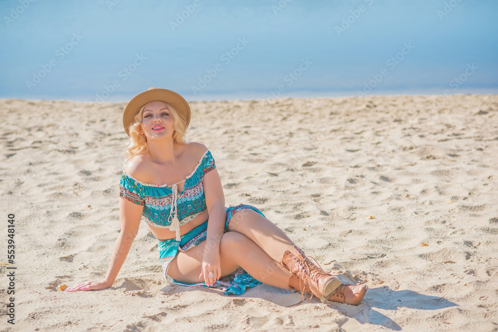 Boho Gypsy American woman in turquoise dress, Fedora light brown hat and boots at beach Boho Gypsy American woman in turquoise dress, Fedora light brown hat and boots at beach