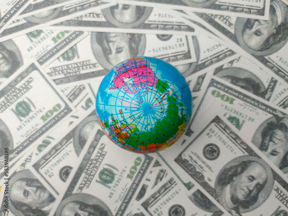 Top view earth globe on a dollar banknotes. Business concept Top view earth globe on a dollar banknotes. Business concept