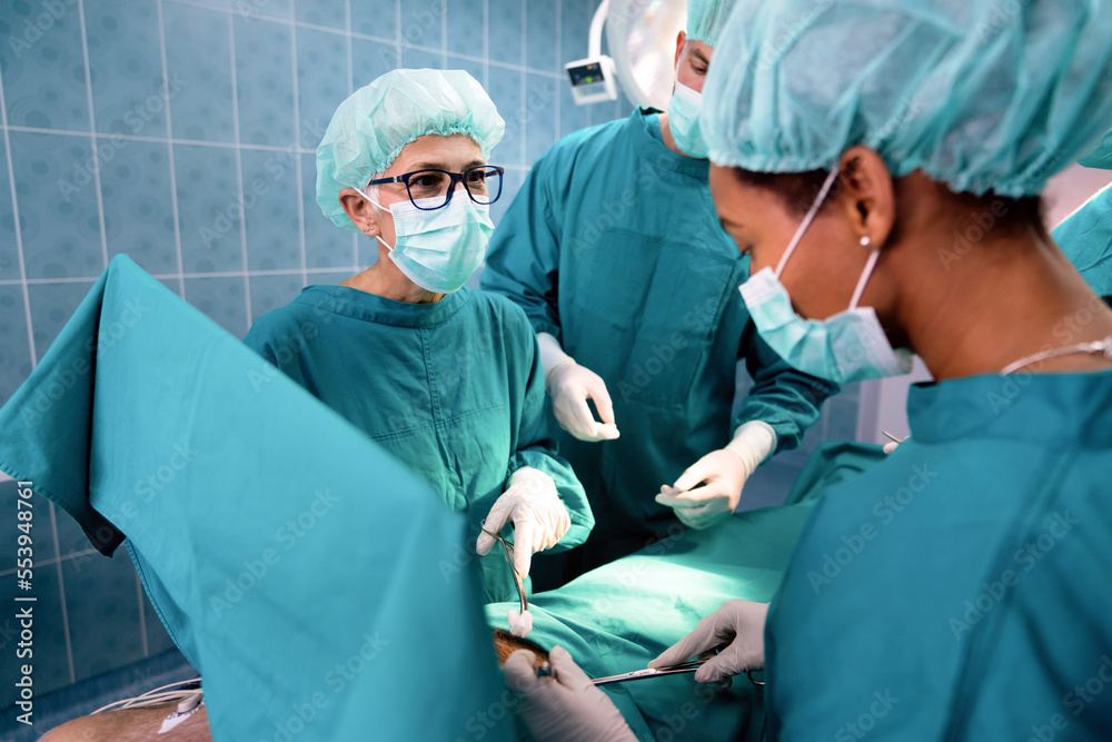 Surgery team operating in a surgical room Surgery team operating in a surgical room