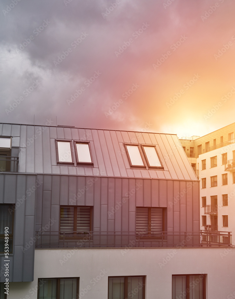 Sunset in modern low-rise flat house district. European contemporary real estate with loft flats. Sunset in modern low-rise flat house district. European contemporary real estate with loft flats.