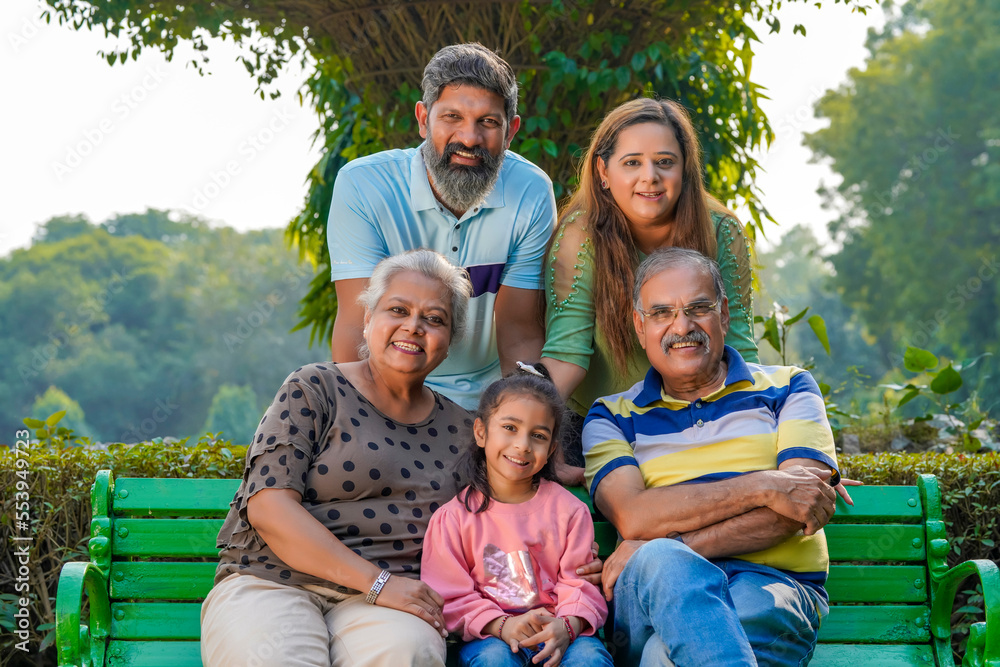 Fototapeta premium Happy indian or asian family sitting at park.