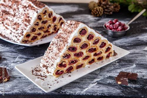 A traditional Moldavian dessert or cake consisting of pancakes with cherry, milk creme and chocolate creme also called Cosma lui Guguta. photo