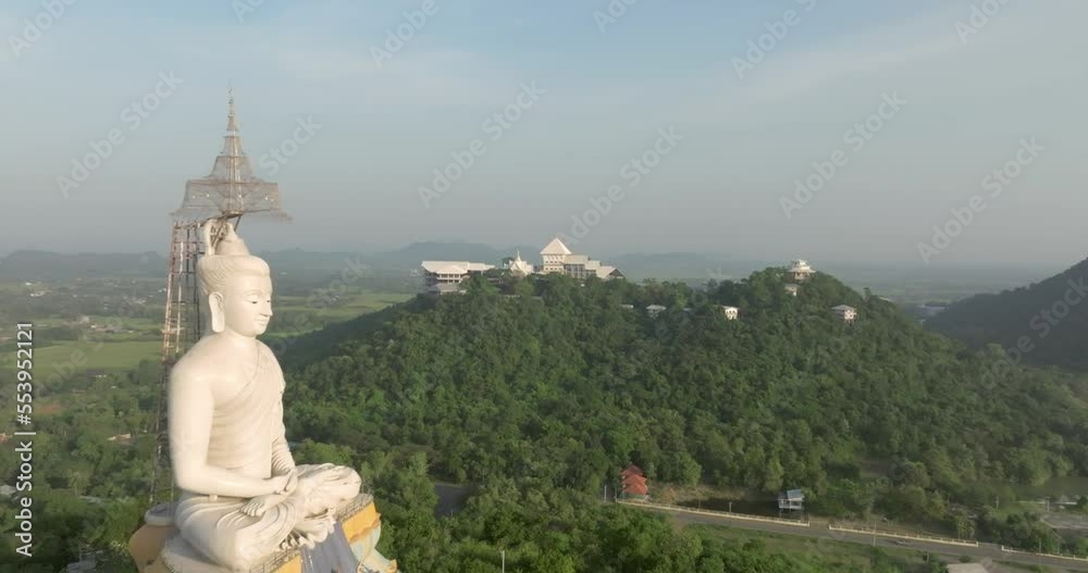 An aerial view of Beautiful Temple on the mountain stands prominently at Wat Nong Hoi in Ratchaburi near the Bangkok, Thailand. An aerial view of Beautiful Temple on the mountain stands prominently at Wat Nong Hoi in Ratchaburi near the Bangkok, Thailand.