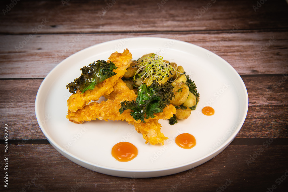 Recipe for Breaded Chicken Tenders and Potatoes with Sesame Kale Chips and Sweet and Sour Sauce. High quality photo Recipe for Breaded Chicken Tenders and Potatoes with Sesame Kale Chips and Sweet and Sour Sauce. High quality photo