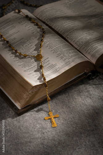  Rosary with cross  on a open holy bible 