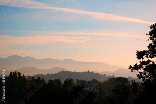 Beautiful rural landscape in autumn. Hilly area in the evening light. Ridge with a high peak in the distance