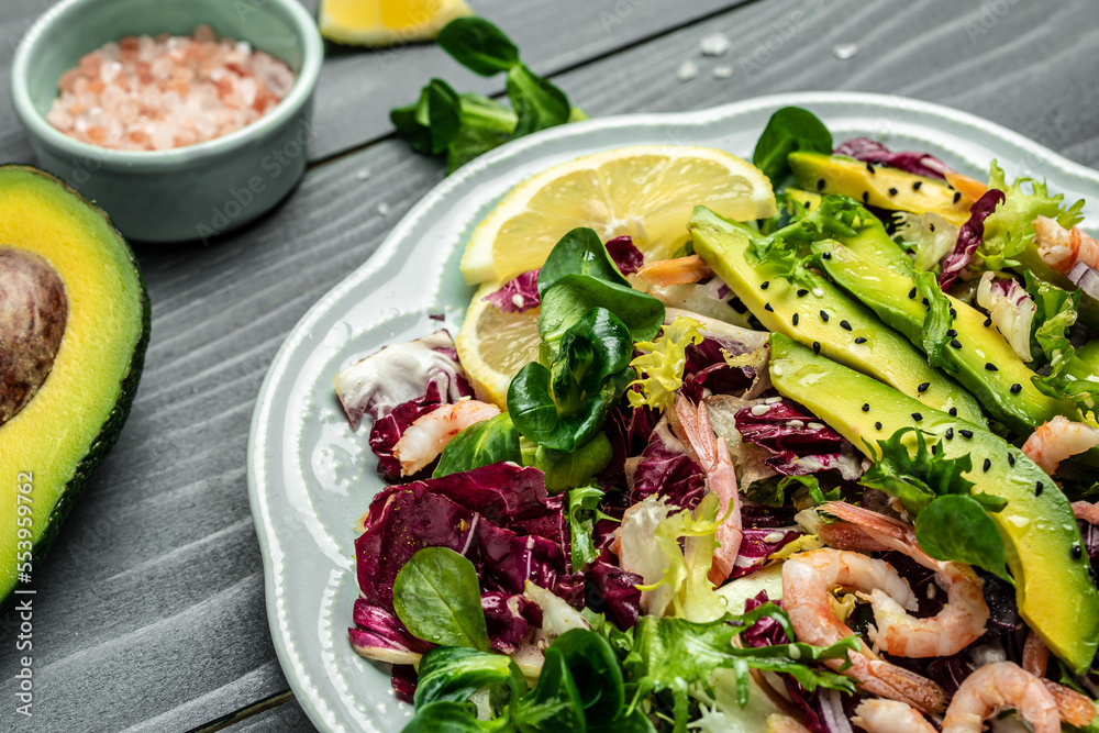 Seafood salad with shrimps, avocado slices and fresh greens, Healthy food. superfood concept. clean eating concept. Vegan or gluten free diet. top view