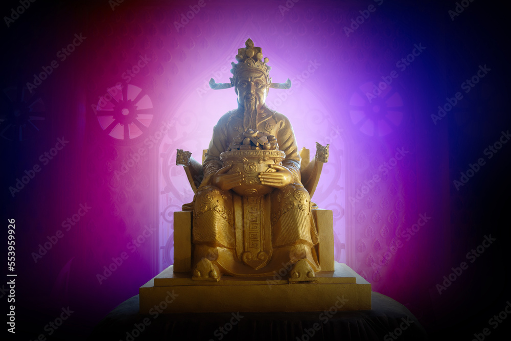 Golden Chinese god of wealth statue worshiped by devotees for wealth and good luck.