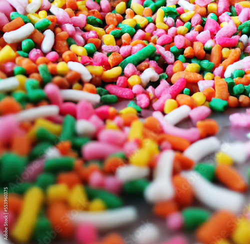 Close up of multiple colorful sweet sprinkles over blurred background created using Generative AI technology